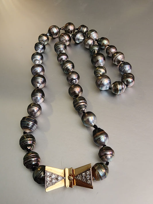 14KT YG CLASP WITH 12 ROUND DIAMONDS EQUALING APPROXIMATELY .24CTS ON A 20" STRAND OF TAHITIAN PEARLS KNOTTED